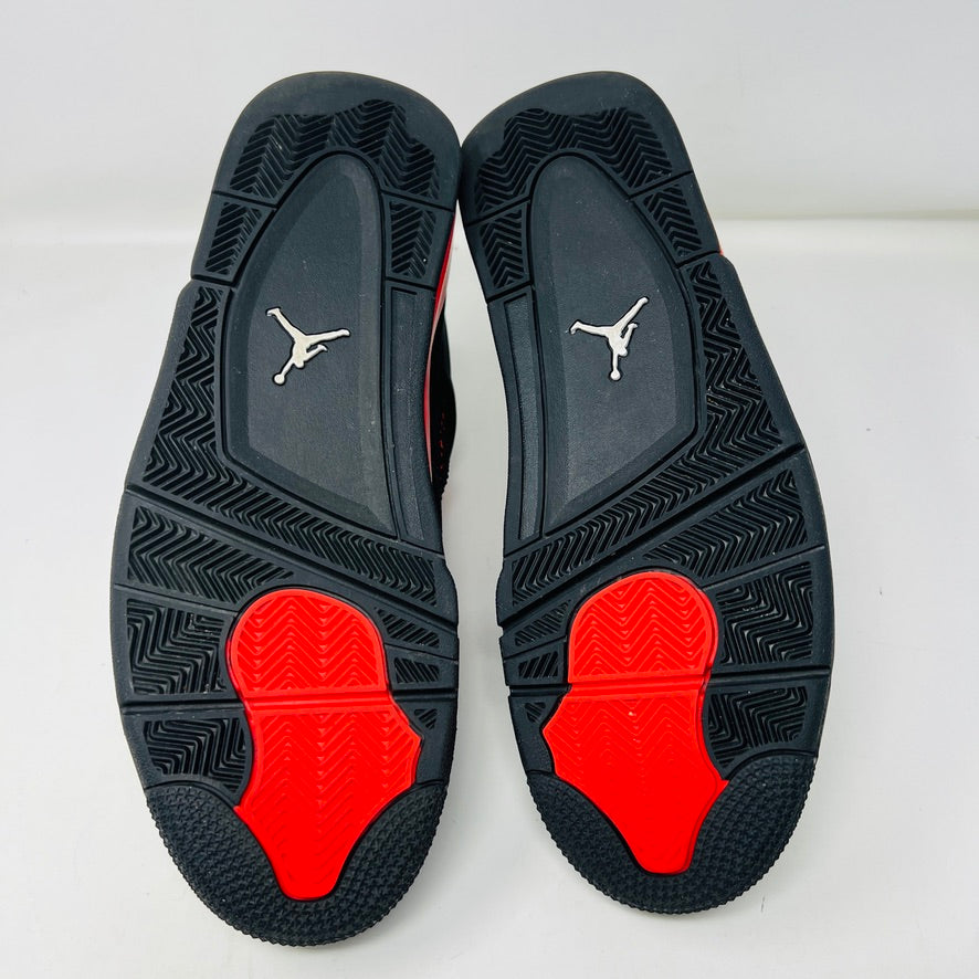 The Jordan 4 Retro Red Thunder sneakers come in an excellent condition shoebox, showcasing clean black uppers with bold red accents on the midsole, eyelets, and mesh. The box features the iconic Air Jordan logo and a shoe information label.