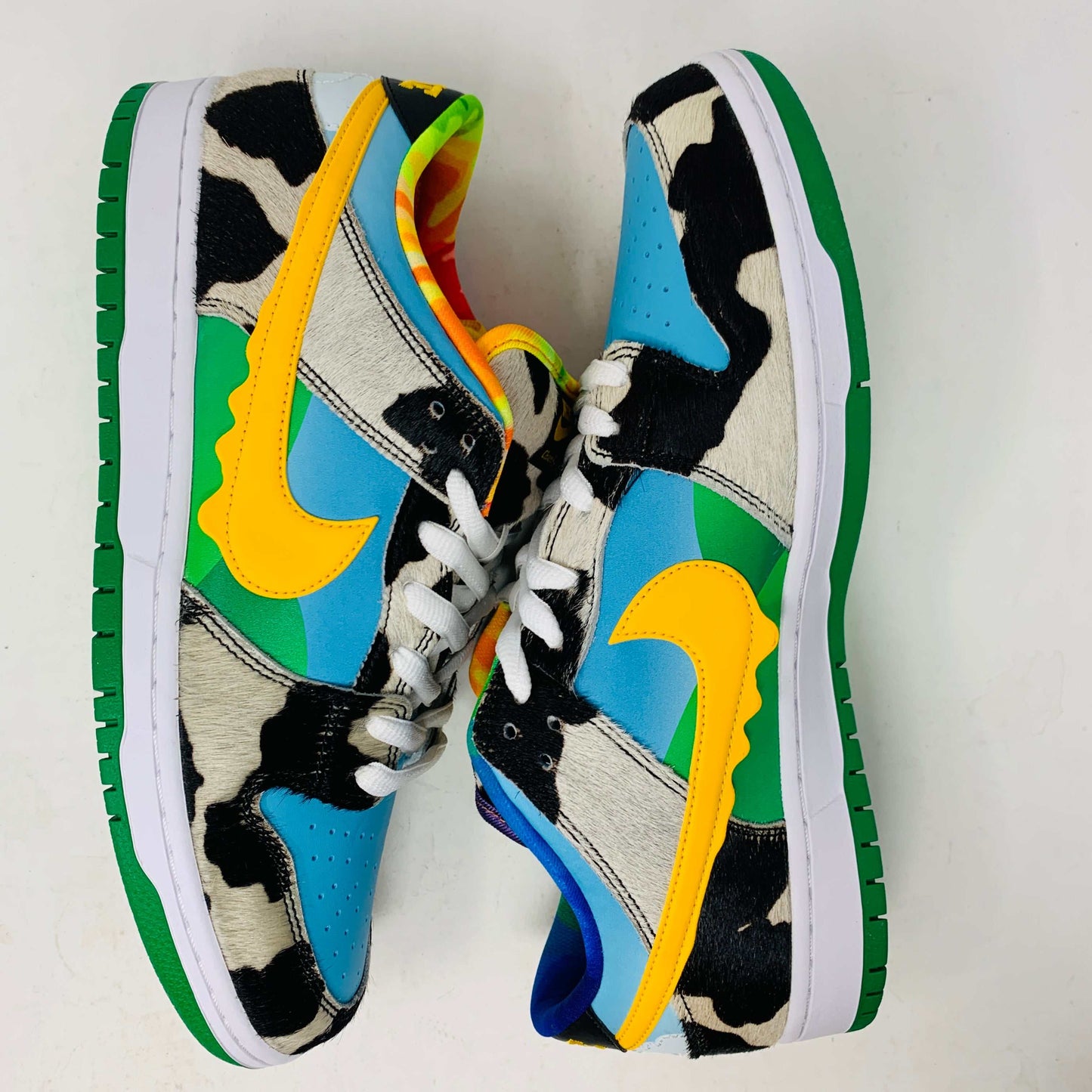 Introducing the new Nike SB Dunk Low Chunky Dunky with a vibrant cow print, featuring blue, green, and yellow sections. This 100% authentic sneaker includes a yellow swoosh and comes in a matching green and yellow box with extra laces, all from Nike.