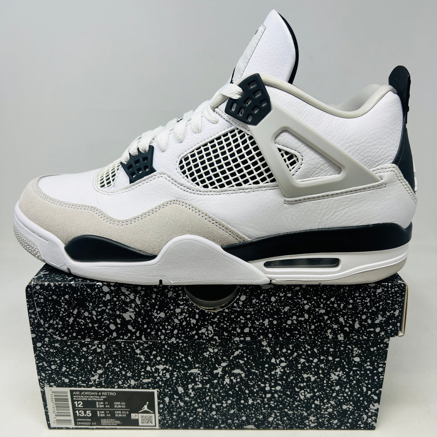 Jordan 4 Retro Military Black sneaker on black speckled box, white and black design, 2022 model