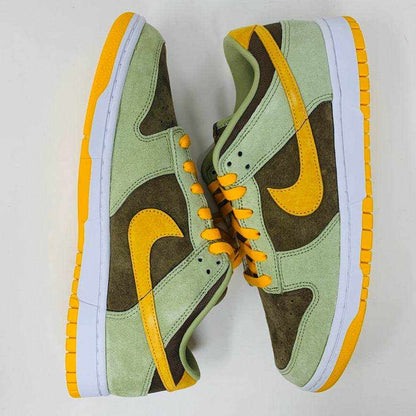 Nike Dunk Low Dusty Olive sneakers on an orange box.