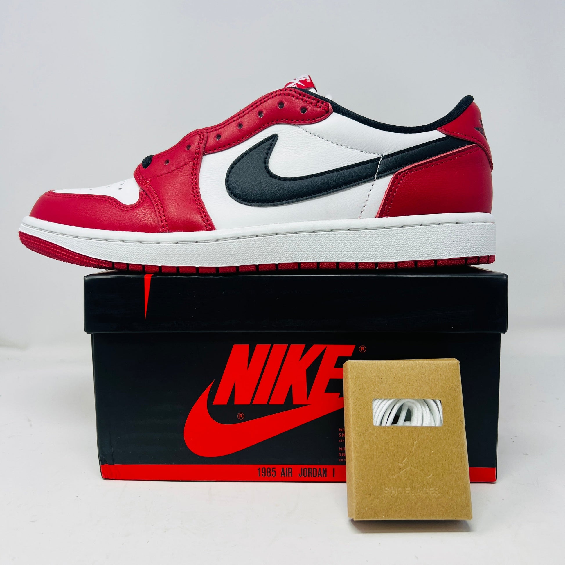 Jordan 1 Retro Low OG Chicago sneaker in red white and black with extra laces on Nike box 2025 edition