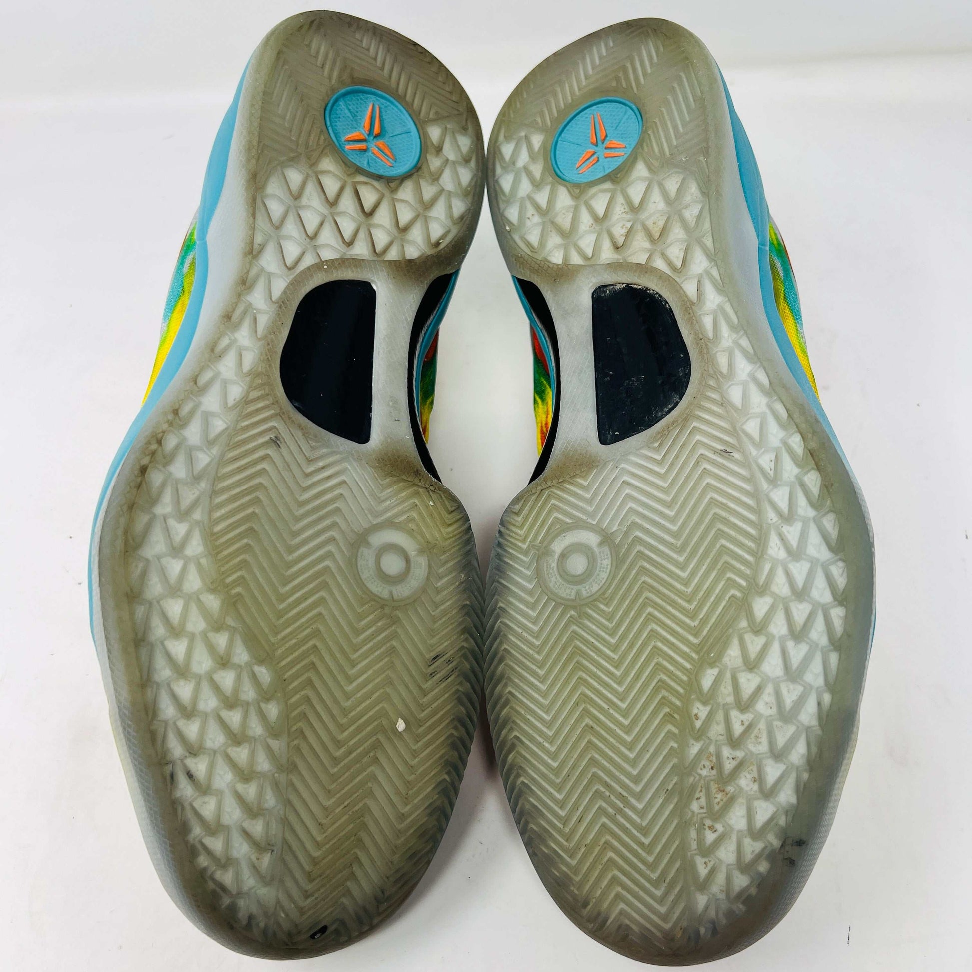 The Nike Kobe 8 Protro Venice Beach (2024) sneakers, featuring vibrant red, blue, yellow, and green brushstroke patterns with clean uppers and yellow laces paired with an orange lining, boast excellent condition at 8.5/10. A distinct logo adorns the gray tongue as they lay side by side on a white background.