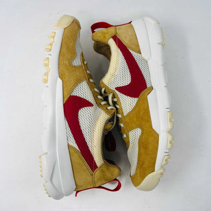 The NikeCraft Mars Yard Shoe 2.0 by Tom Sachs Space Camp features white mesh, tan suede accents, red Nike logos on the tongues, red heel pull tabs, and white laces. This 100% authentic sneaker is perfect for elevating any outfit with style.
