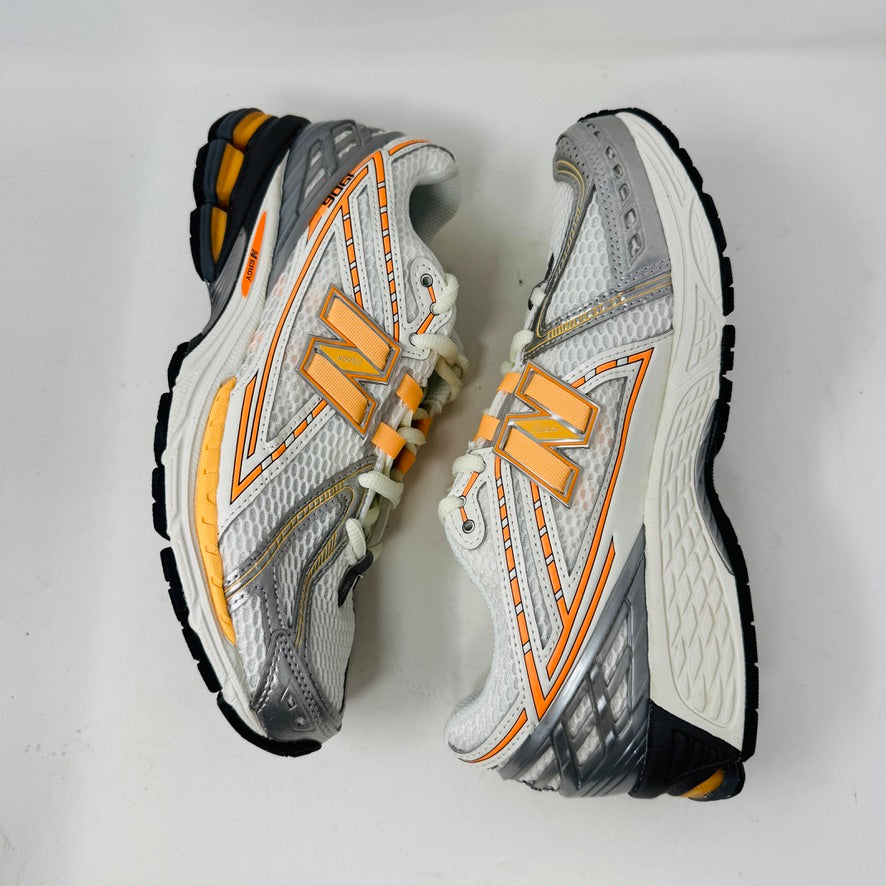 New Balance 1906R ASOS Exclusive Neon Pack in orange on display box.