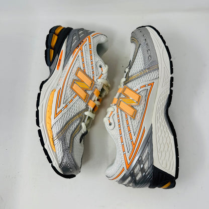 New Balance 1906R ASOS Exclusive Neon Pack in orange on display box.