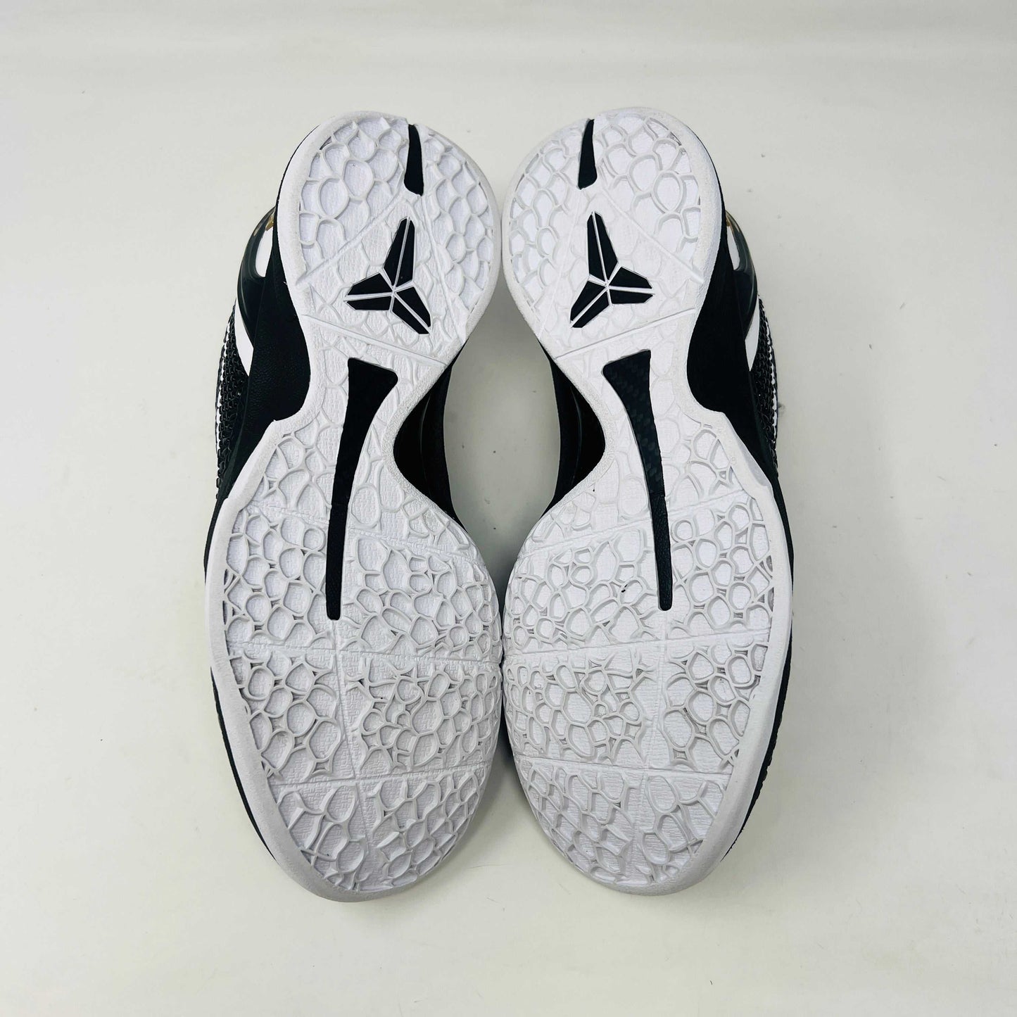 The black and white Nike Kobe 6 Protro Mambacita Sweet 16 shoe features a glossy finish, a gold number 2 on the heel, and light wear with a minor scratch on the back tab. It comes in sizes 8 and 9.5, displayed on a black box labeled Kobe V Proto, and is guaranteed authentic by KOBE.