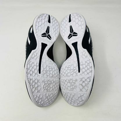The black and white Nike Kobe 6 Protro Mambacita Sweet 16 shoe features a glossy finish, a gold number 2 on the heel, and light wear with a minor scratch on the back tab. It comes in sizes 8 and 9.5, displayed on a black box labeled Kobe V Proto, and is guaranteed authentic by KOBE.