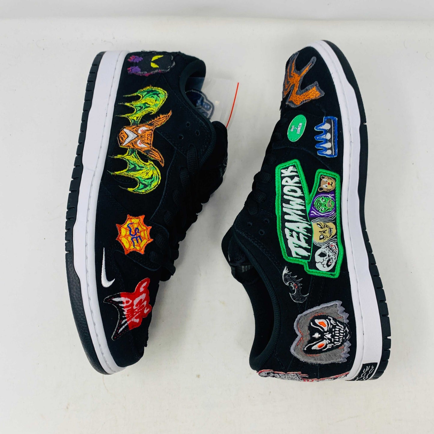 Authentic Nike SB Dunk Low Neckface sneakers, showcasing colorful animal and abstract patches, come in a vibrant green, yellow, and blue Nike SB box on a plain background. All sales final.
